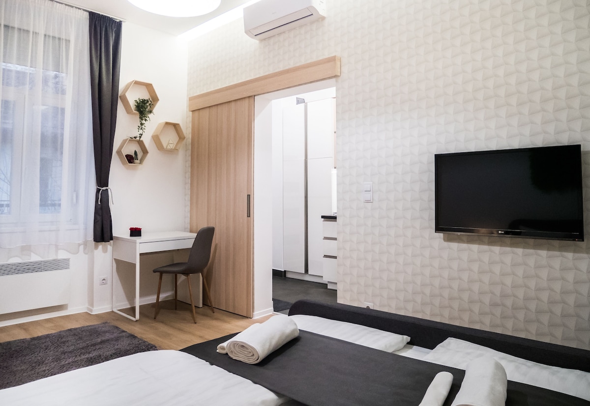 Bedroom with double bed, television and desk